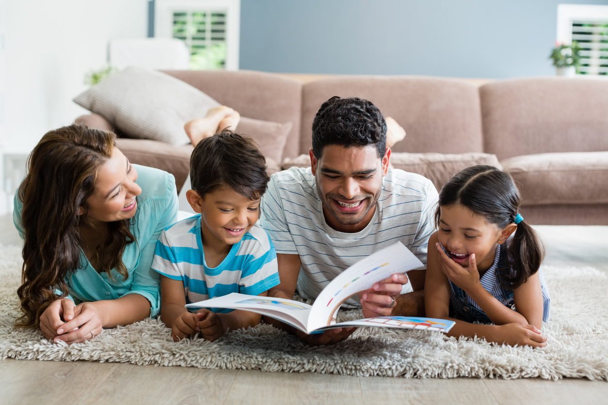 A family reading together on the floor