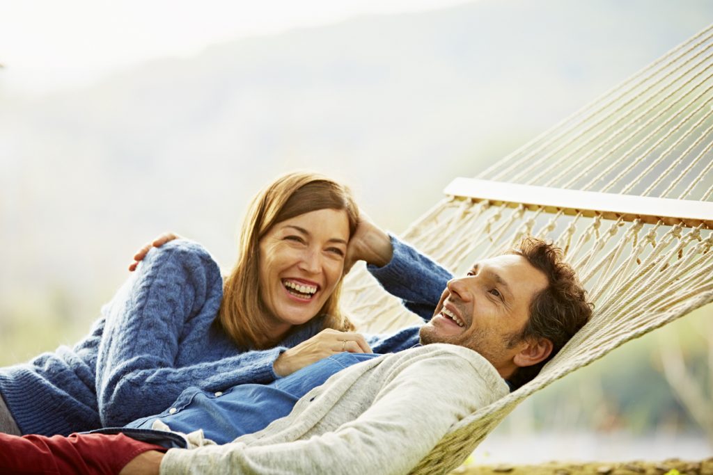 Couple laying in a hammock relaxing