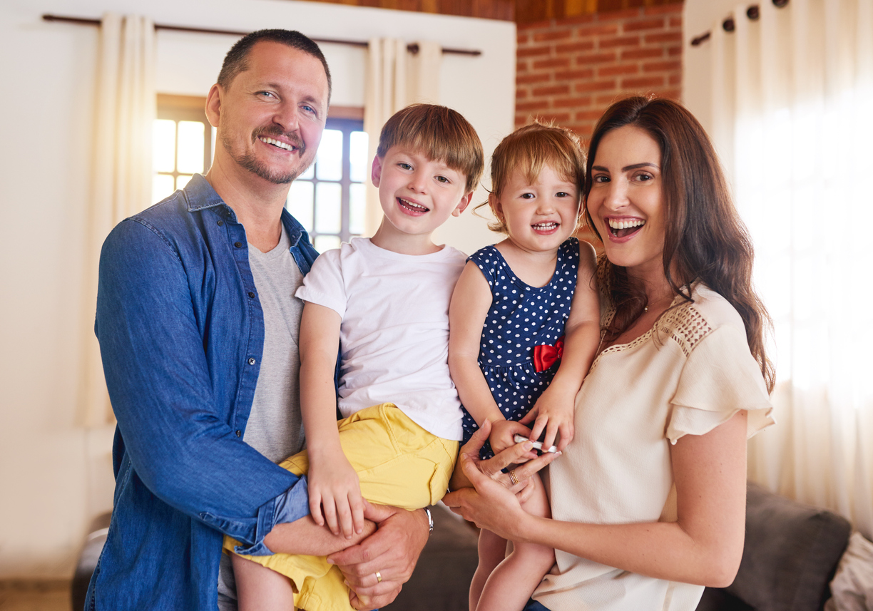 Portrait of a happy young family spending quality time together at at home